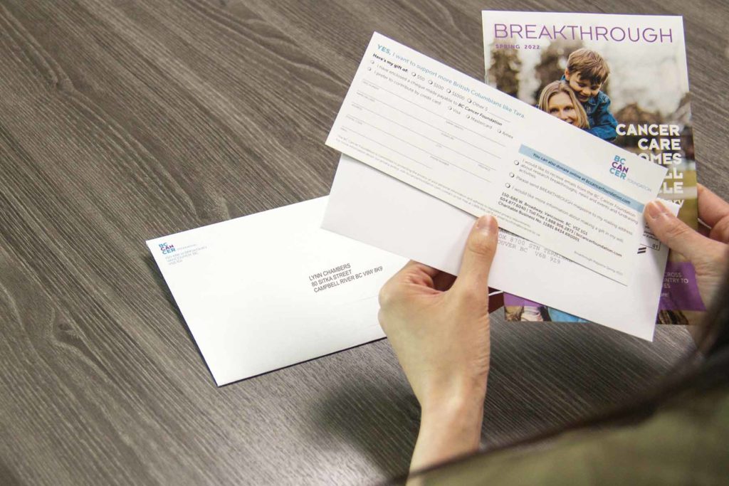 a person looking at a non profit direct mail campaign